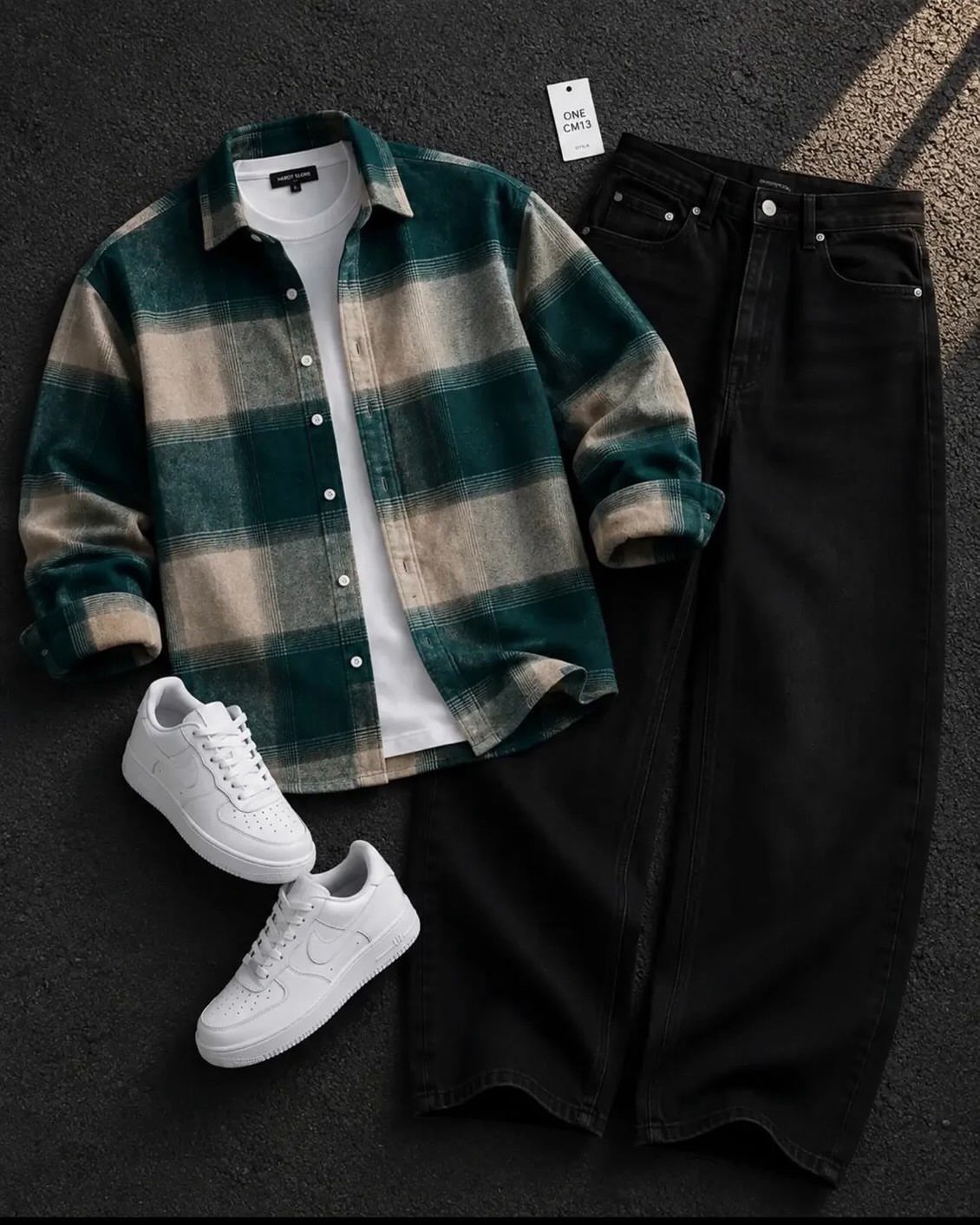 A green plaid flannel shirt over a white t-shirt with black jeans and white sneakers.