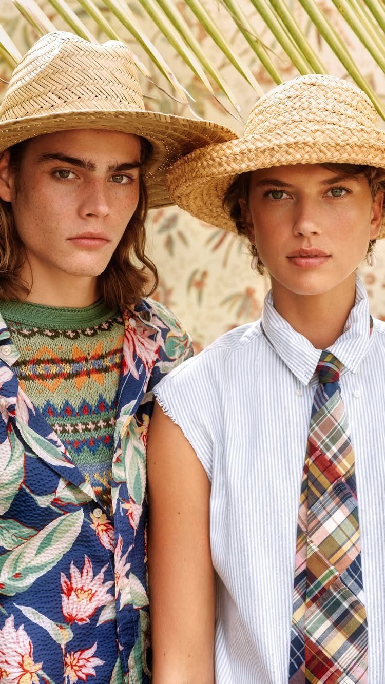Two people wearing straw hats and various patterned clothing including floral, geometric, striped, and plaid designs.
