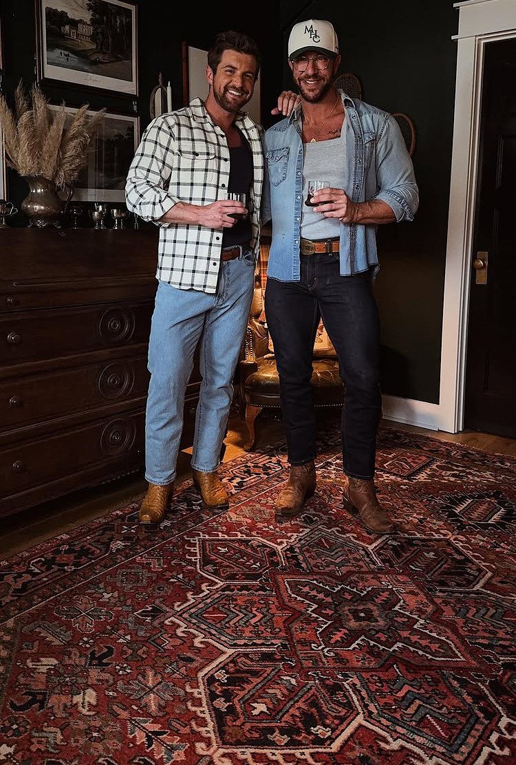 Two men posing in casual outfits including plaid and denim shirts with jeans.