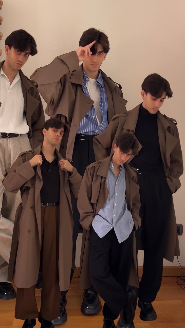 Five young men posing together while wearing various styles of tan and brown trench coats.